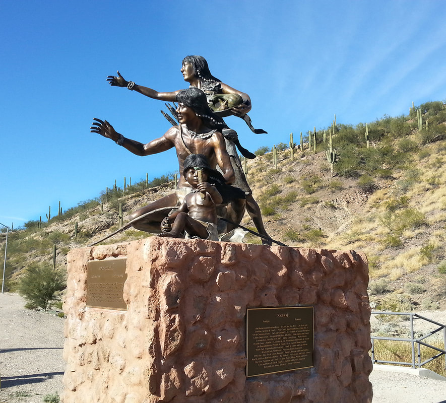 Tohono O'Odham Family Monument - broze cast sculpture with a mother, child, and father looking into the distance