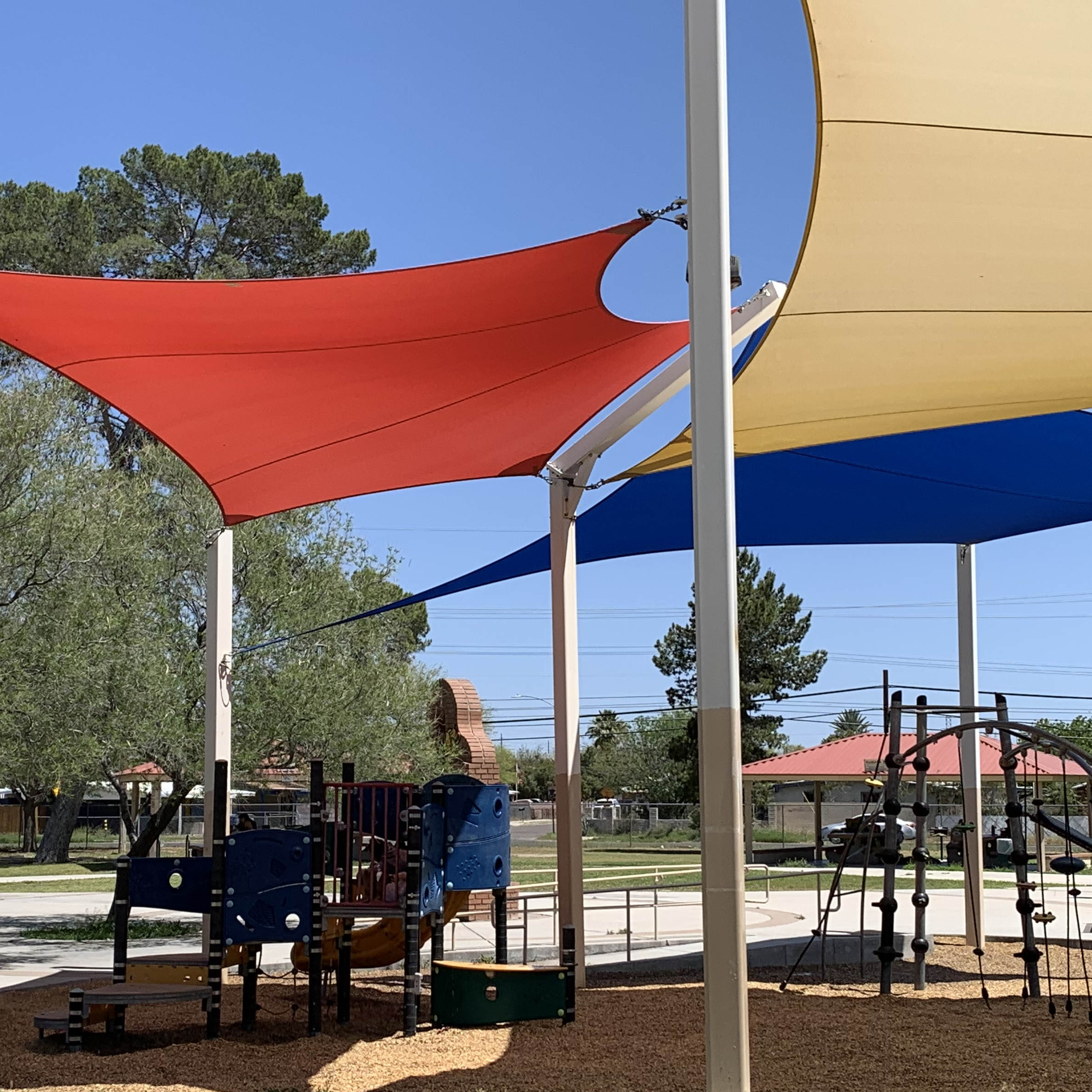 Play structure and bright colored shade sails at menlo park