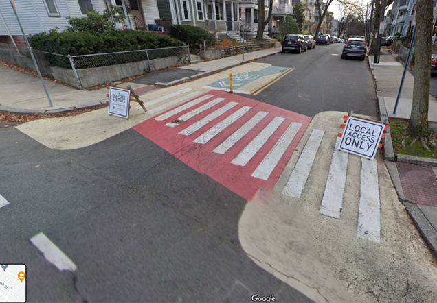 A Google Maps image of a street with "Local Access Only" signage, painted crosswalks and no parking zones for daylighting 